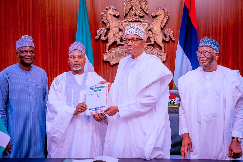 Buhari receiving the asset declaration form in Abuja today